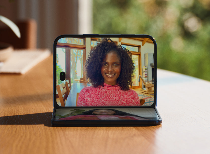 Apple iPhone Duo folded at an angle on a table during a FaceTime call